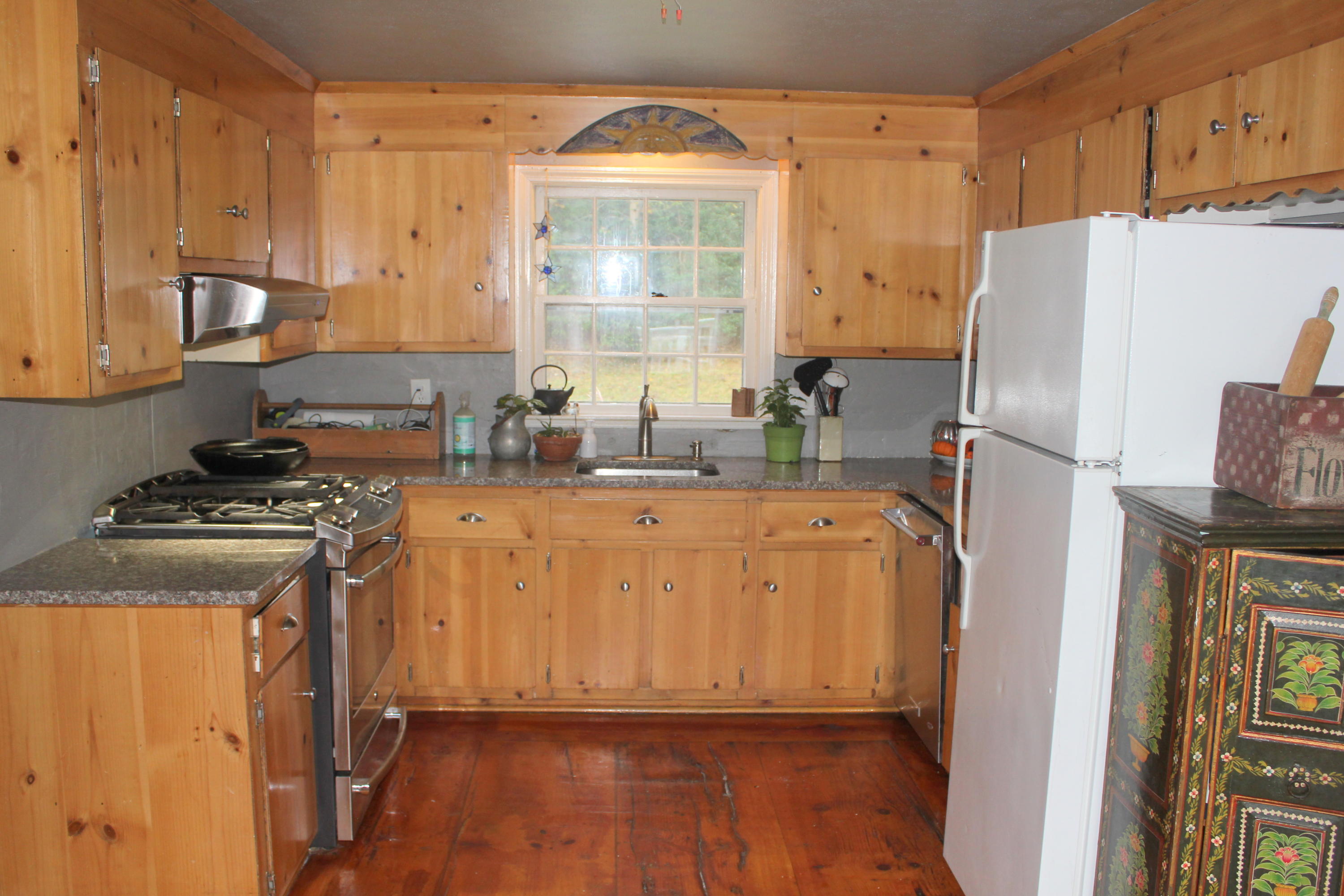 128 Turtleback Road Marstons Mills, MA 02648 - Photo 2 of 20 a kitchen with stainless steel appliances granite countertop a refrigerator a stove and a sink with wooden floor