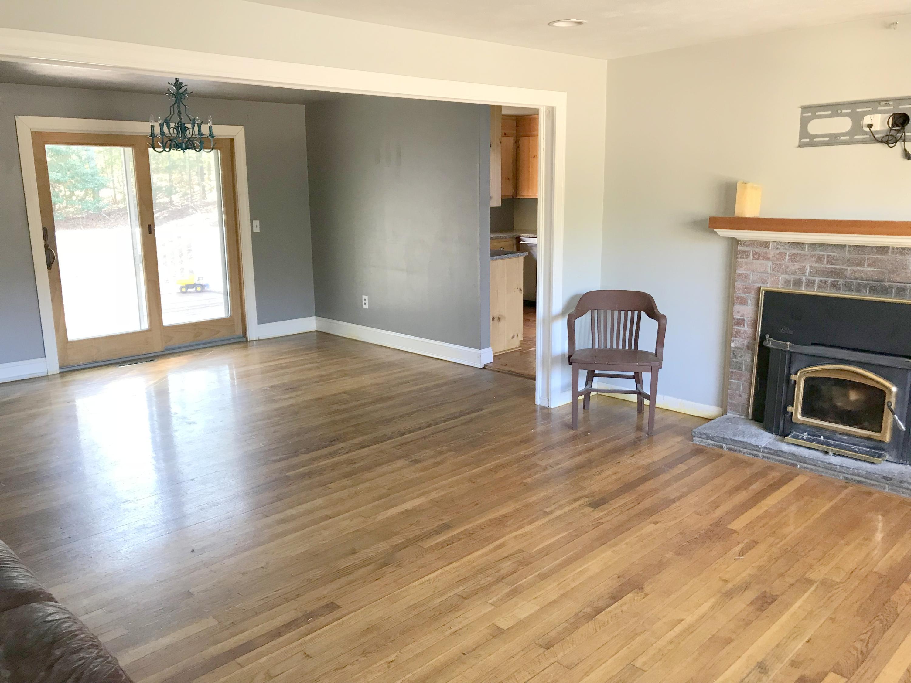 128 Turtleback Road Marstons Mills, MA 02648 - Photo 7 of 20 a view of a livingroom with wooden floor and a fireplace