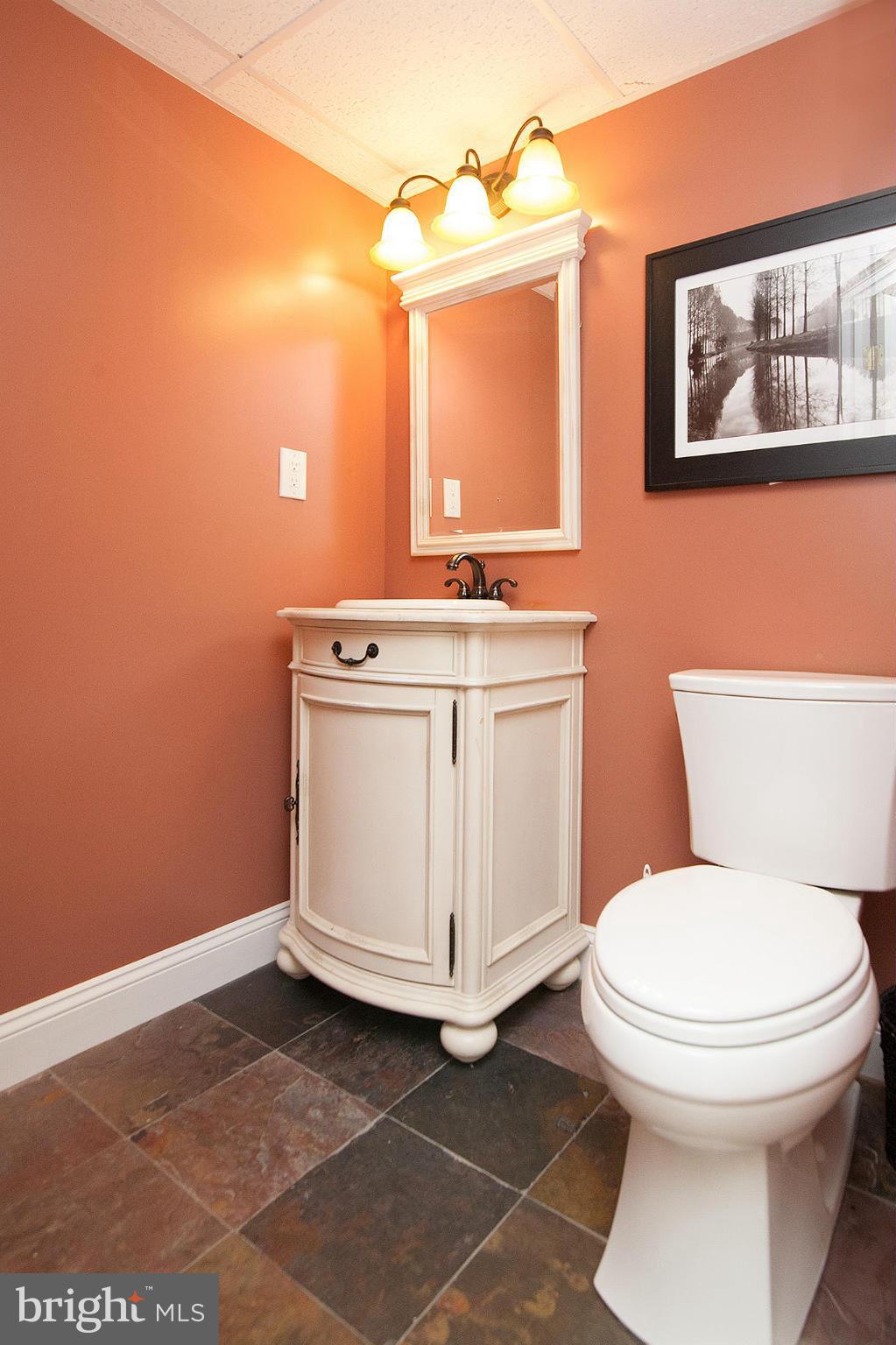 3213 Atlee Ridge Road New Windsor, MD 21776 - Photo 14 of 29 a bathroom with a toilet sink and mirror
