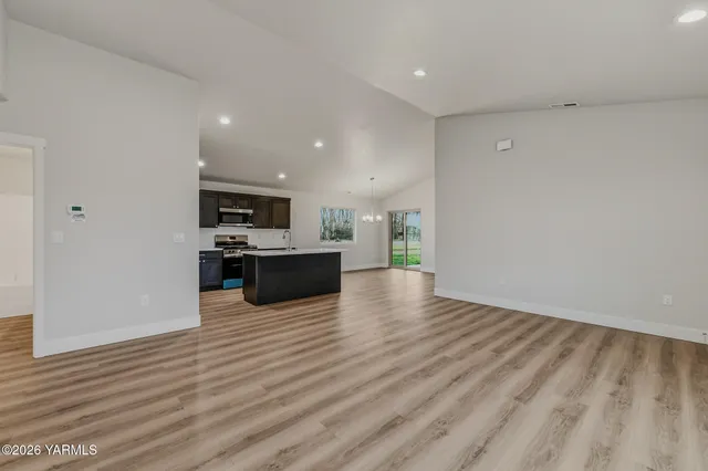 a view of kitchen with microwave and cabinets