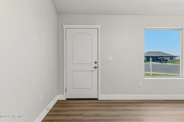 a view of a livingroom with wooden floor and a window