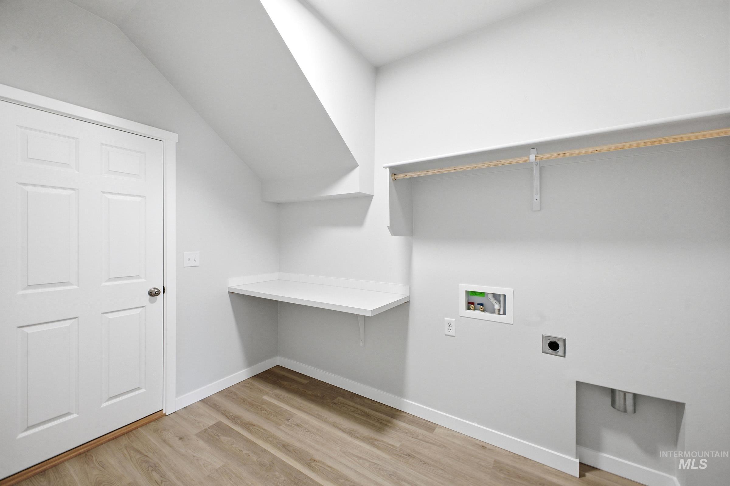 14104 Shiny Spruce Street Caldwell, ID 83607 - Photo 13 of 20 Utility room with wood-finish flooring, built-in countertop, shelving, and laundry hookups