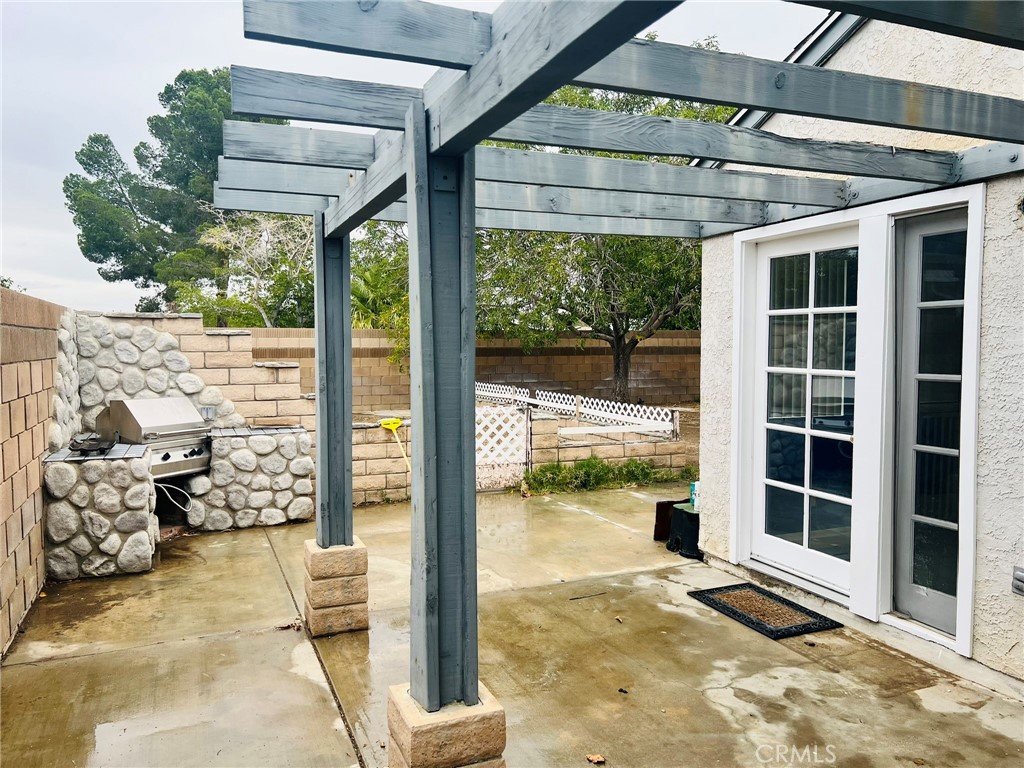 3607 Apollo Avenue Palmdale, CA 93550 - Photo 14 of 17 a view of a porch with furniture and floor to ceiling windows