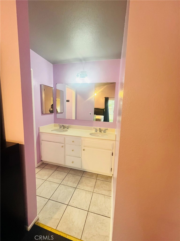 3607 Apollo Avenue Palmdale, CA 93550 - Photo 9 of 17 a bathroom with a sink a toilet and mirror