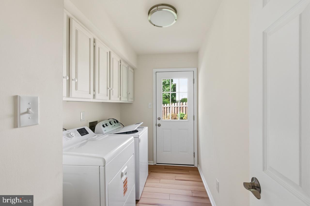 7100 Counter Place Burke, VA 22015 - Photo 21 of 54 Main floor laundry with washer and dryer.