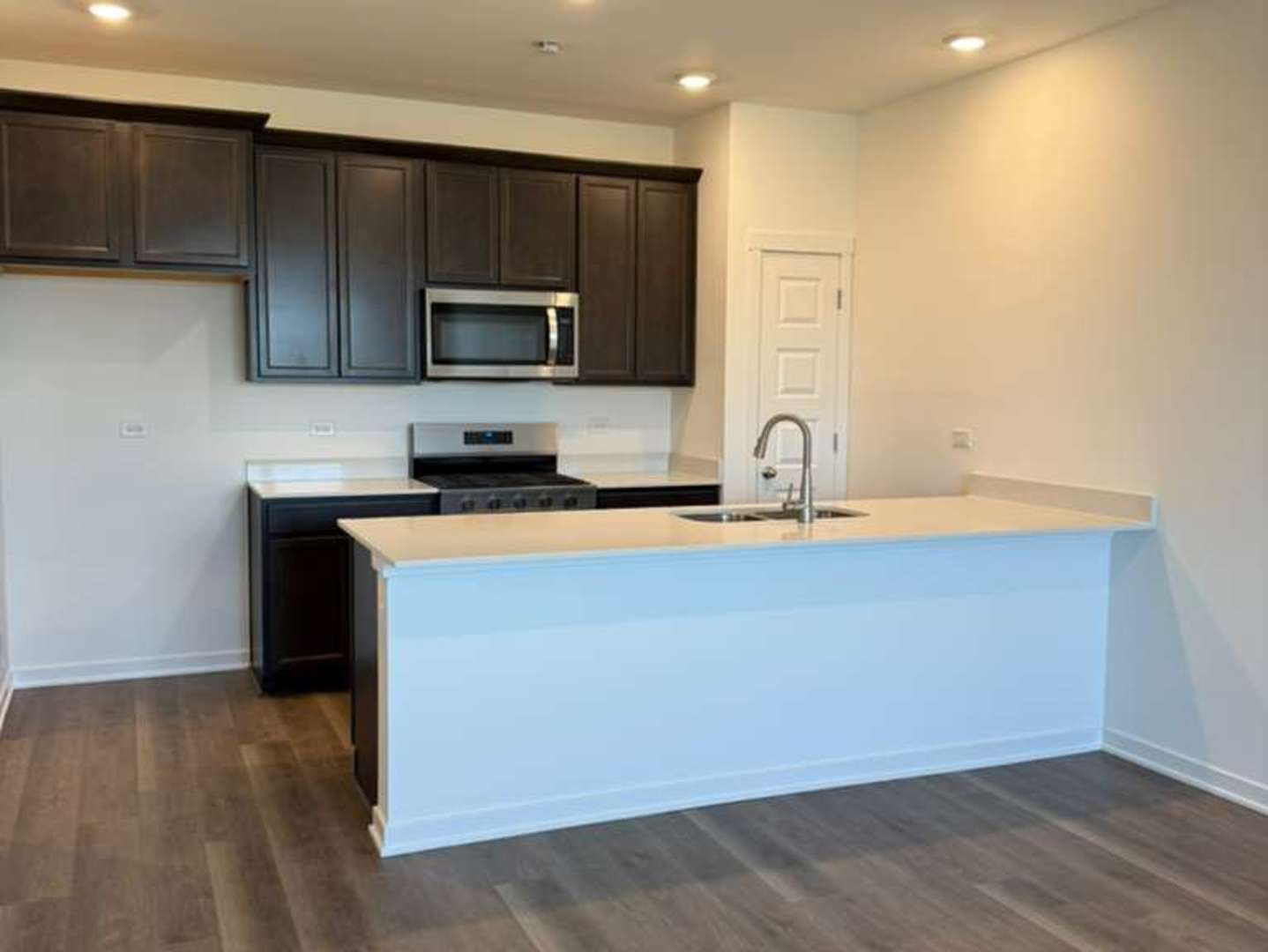 2251 Riesling Road Oswego, IL 60543 - Photo 3 of 13 a kitchen with stainless steel appliances a sink a stove a microwave a sink and a refrigerator