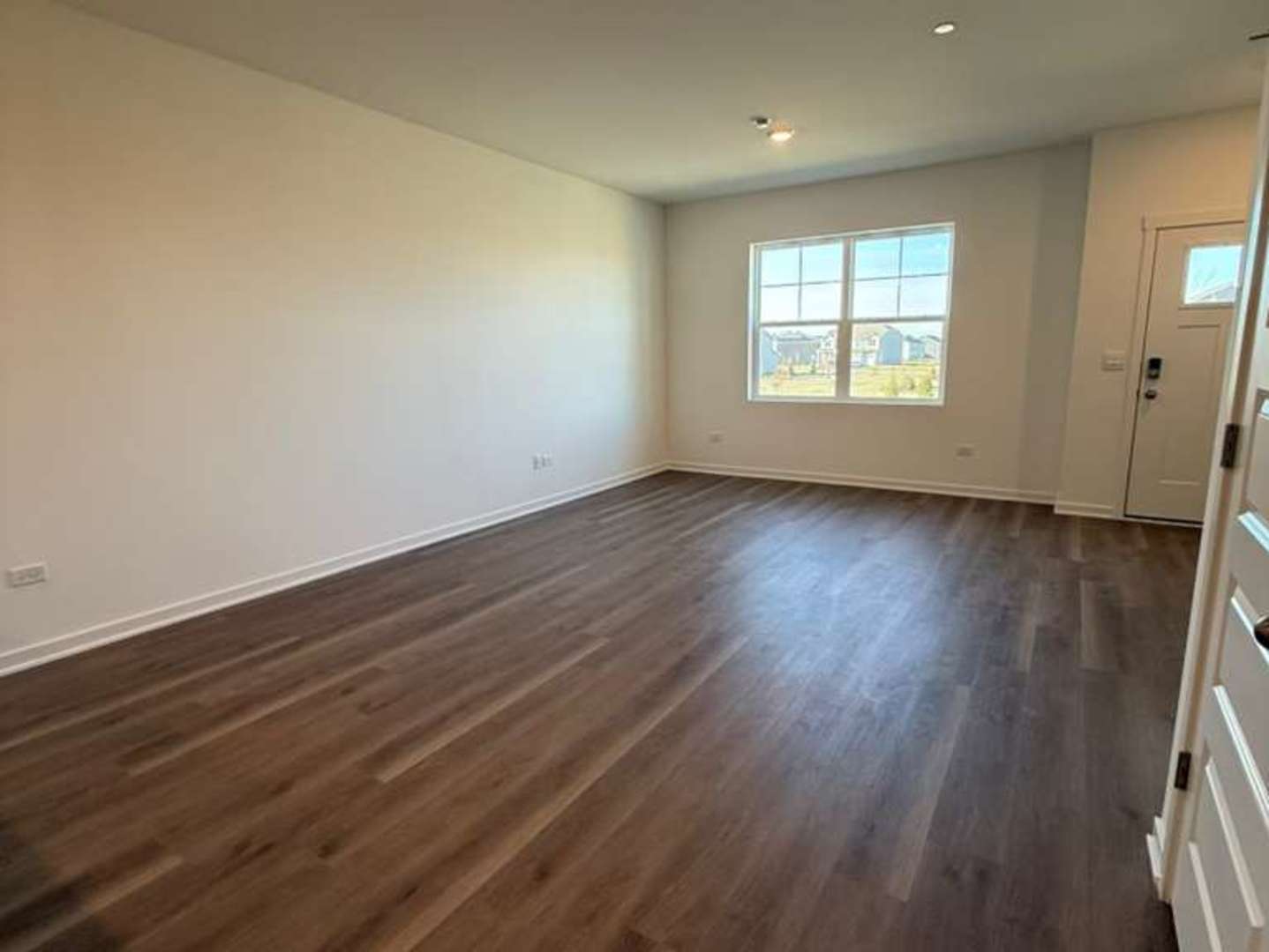 2251 Riesling Road Oswego, IL 60543 - Photo 6 of 13 an empty room with wooden floor and window