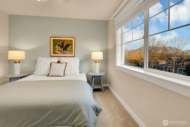 a bedroom with a bed and a painting on the wall