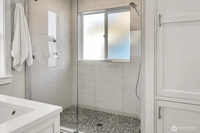 a bathroom with a bathtub and shower