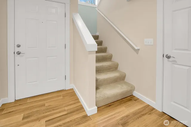 a view of entryway and hall with wooden floor