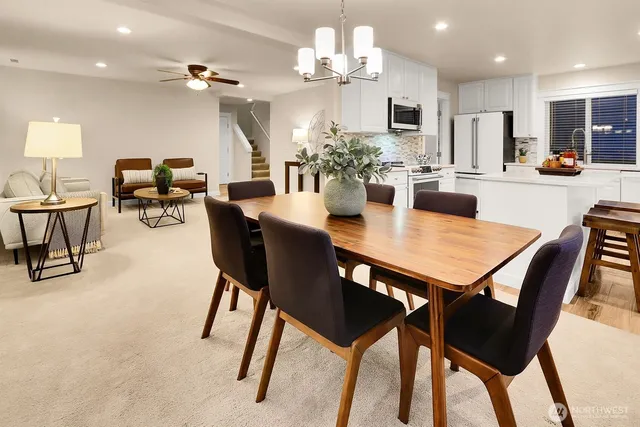 a view of a dining room with furniture and a chandelier
