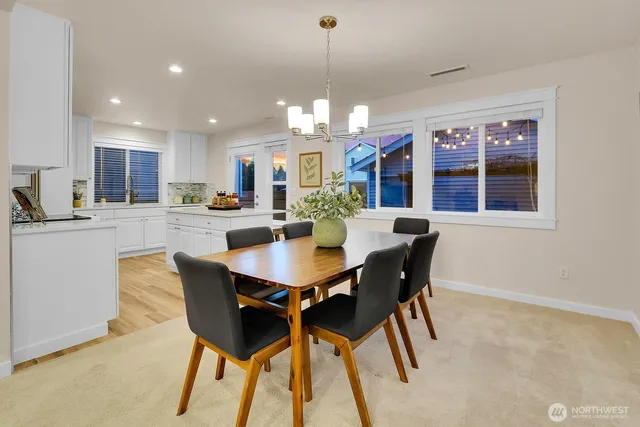 a view of a dining room with furniture and window