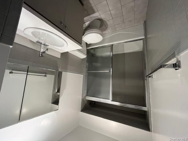 10 Inwood Road, Unit B Port Washington, NY 11050 - Photo 13 of 18 a bathroom with a sink toilet and shower