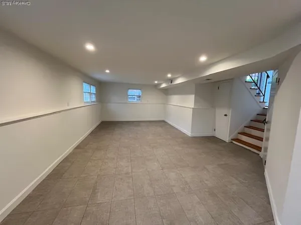 a view of an empty room with stairs