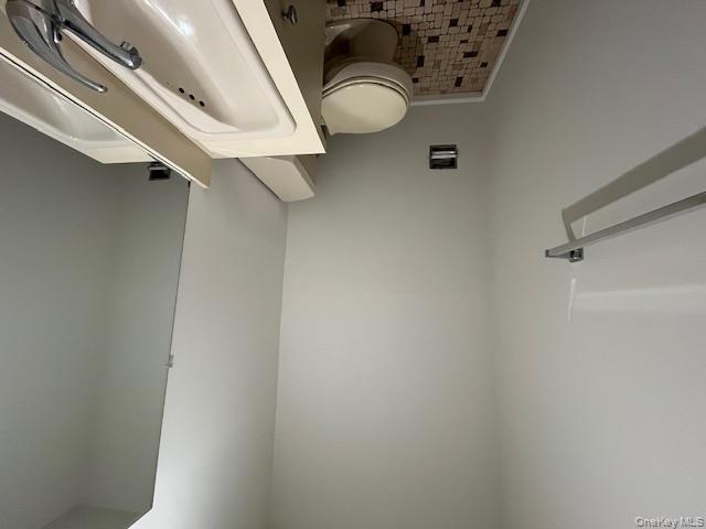 10 Inwood Road, Unit B Port Washington, NY 11050 - Photo 6 of 18 a white toilet sitting next to a shower