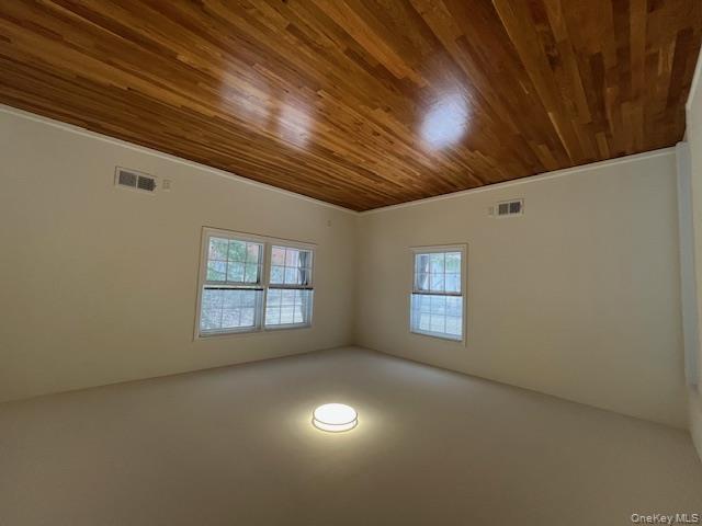 10 Inwood Road, Unit B Port Washington, NY 11050 - Photo 8 of 18 an empty room with wooden floor and windows