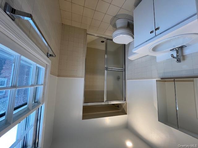 10 Inwood Road, Unit B Port Washington, NY 11050 - Photo 10 of 18 a bathroom with a granite countertop sink toilet and shower