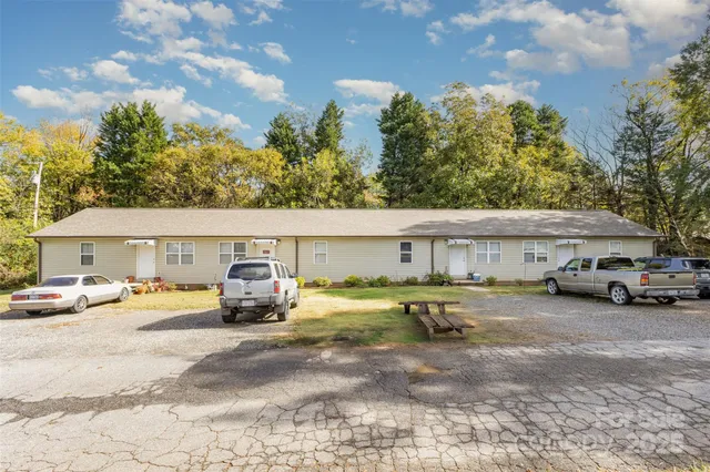 a view of a house with swimming pool and sitting area