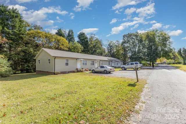 a view of a kitchen with stainless steel appliances granite countertop a refrigerator and a stove top oven
