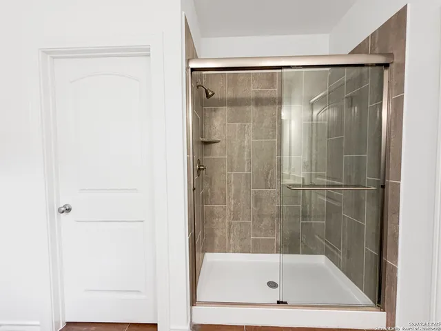 a bathroom with a glass shower door