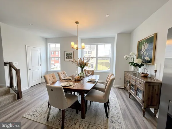 a view of a big room with windows and chandelier fan