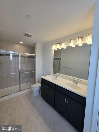 a bathroom with a sink mirror and a shower