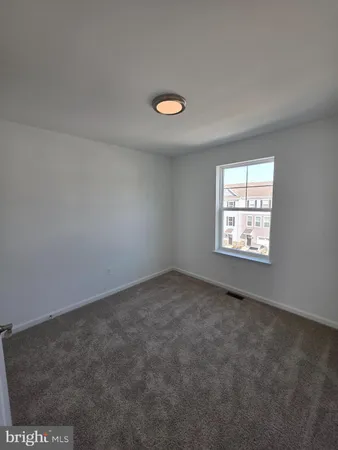a bedroom with bed and a window