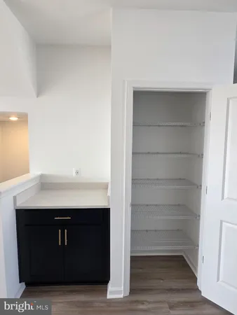 a view of kitchen cabinets and wooden floor