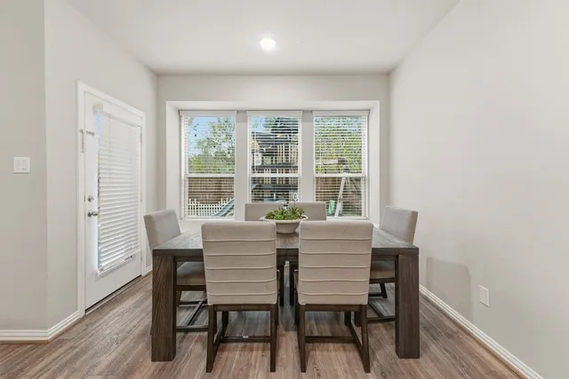 a view of a dining room with furniture and wooden floor