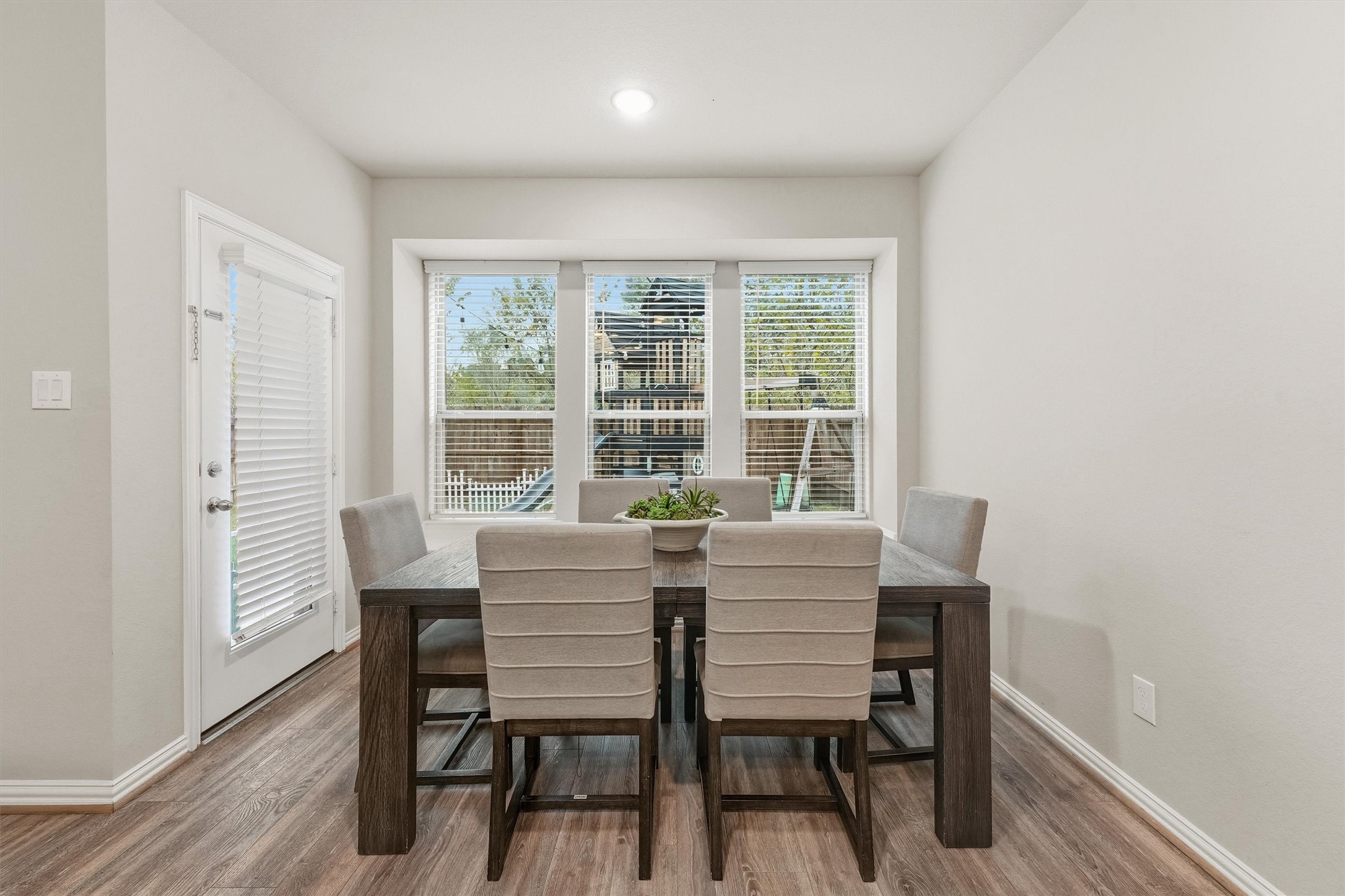 7119 Mystic Morning Lane Spring, TX 77379 - Photo 11 of 30 a view of a dining room with furniture and wooden floor