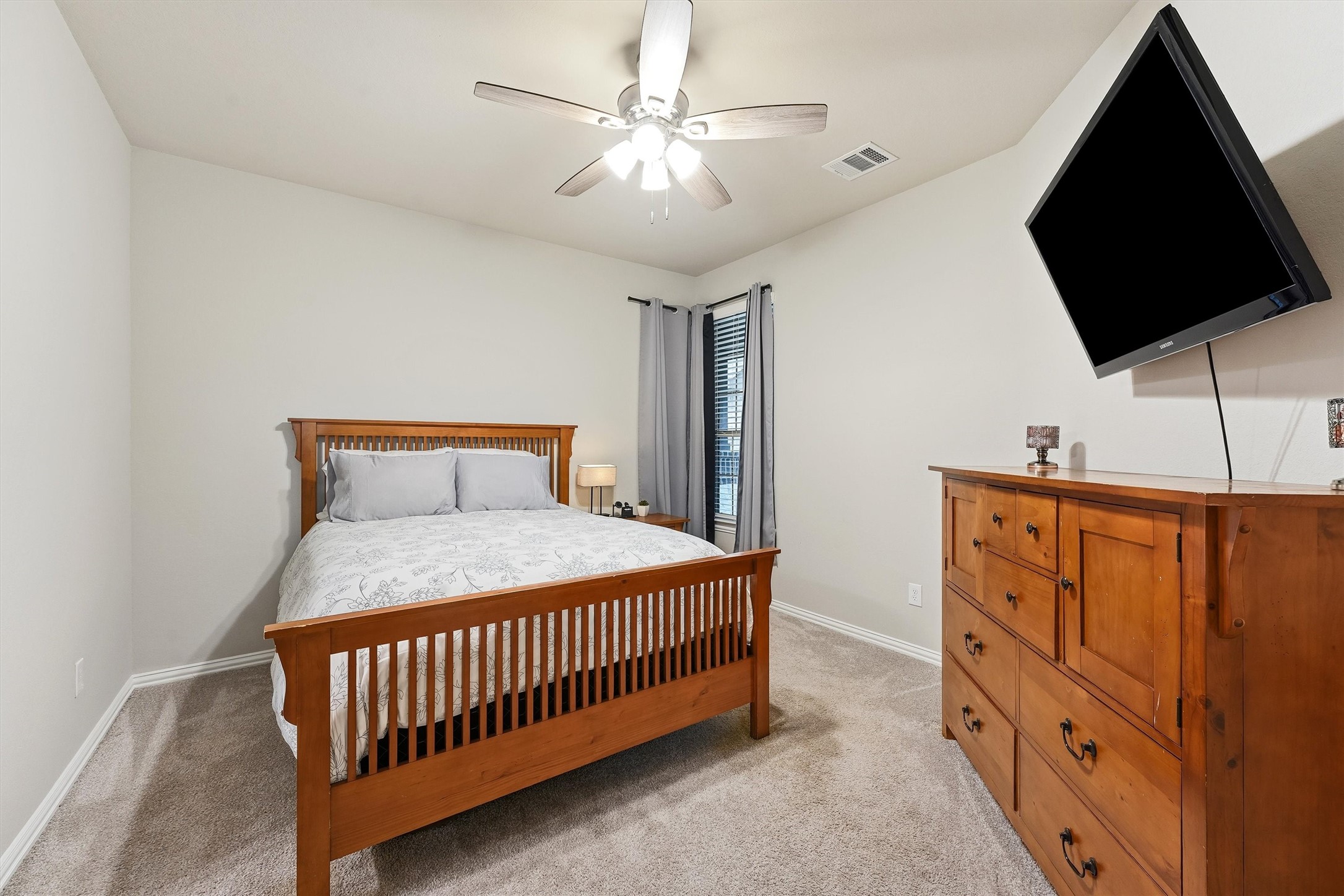 7119 Mystic Morning Lane Spring, TX 77379 - Photo 12 of 30 a bedroom with a bed and flat screen tv