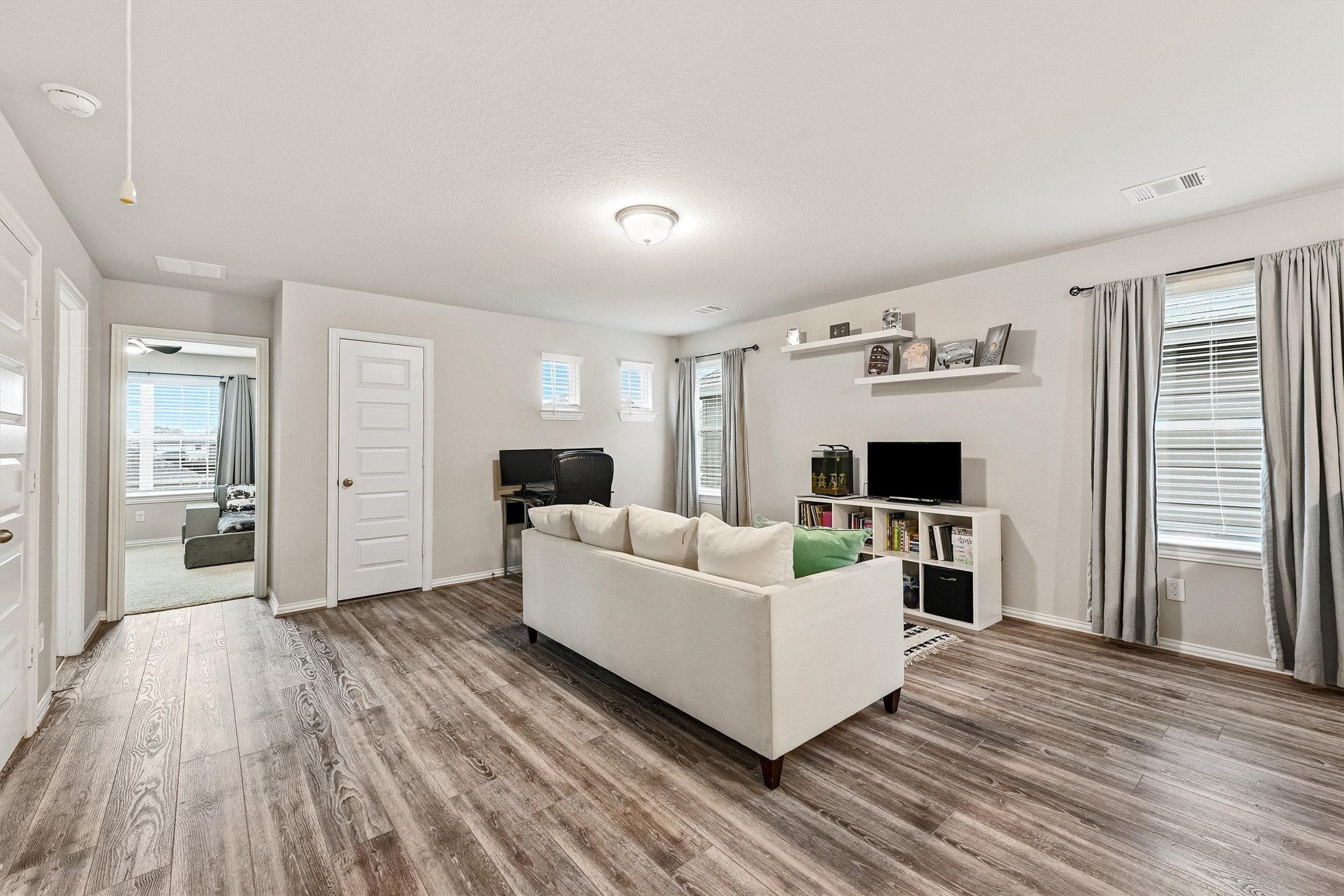 7119 Mystic Morning Lane Spring, TX 77379 - Photo 17 of 30 a living room with furniture and a wooden floor