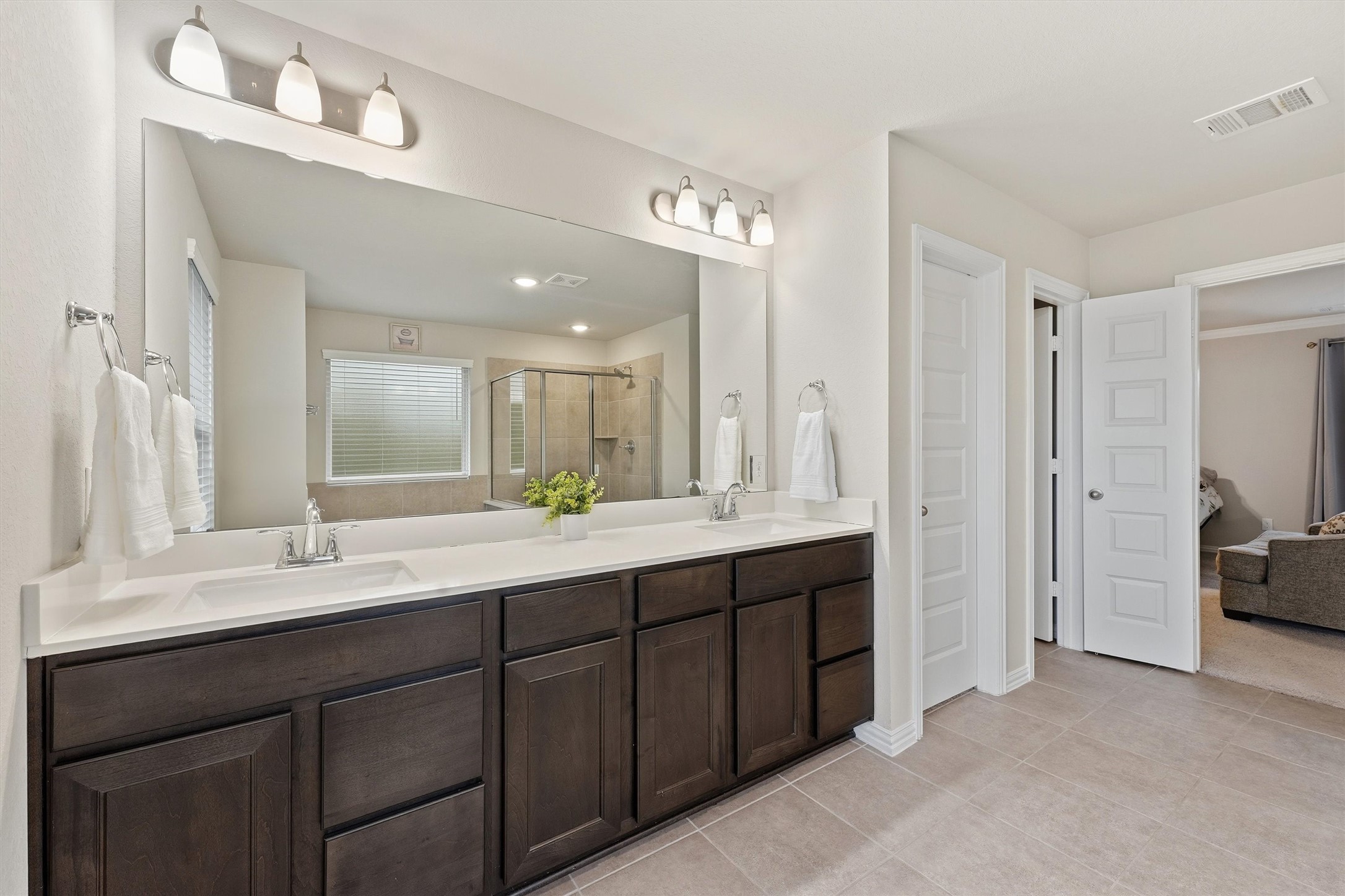 7119 Mystic Morning Lane Spring, TX 77379 - Photo 19 of 30 a bathroom with double vanity sinks a vanity a lamp and a mirror