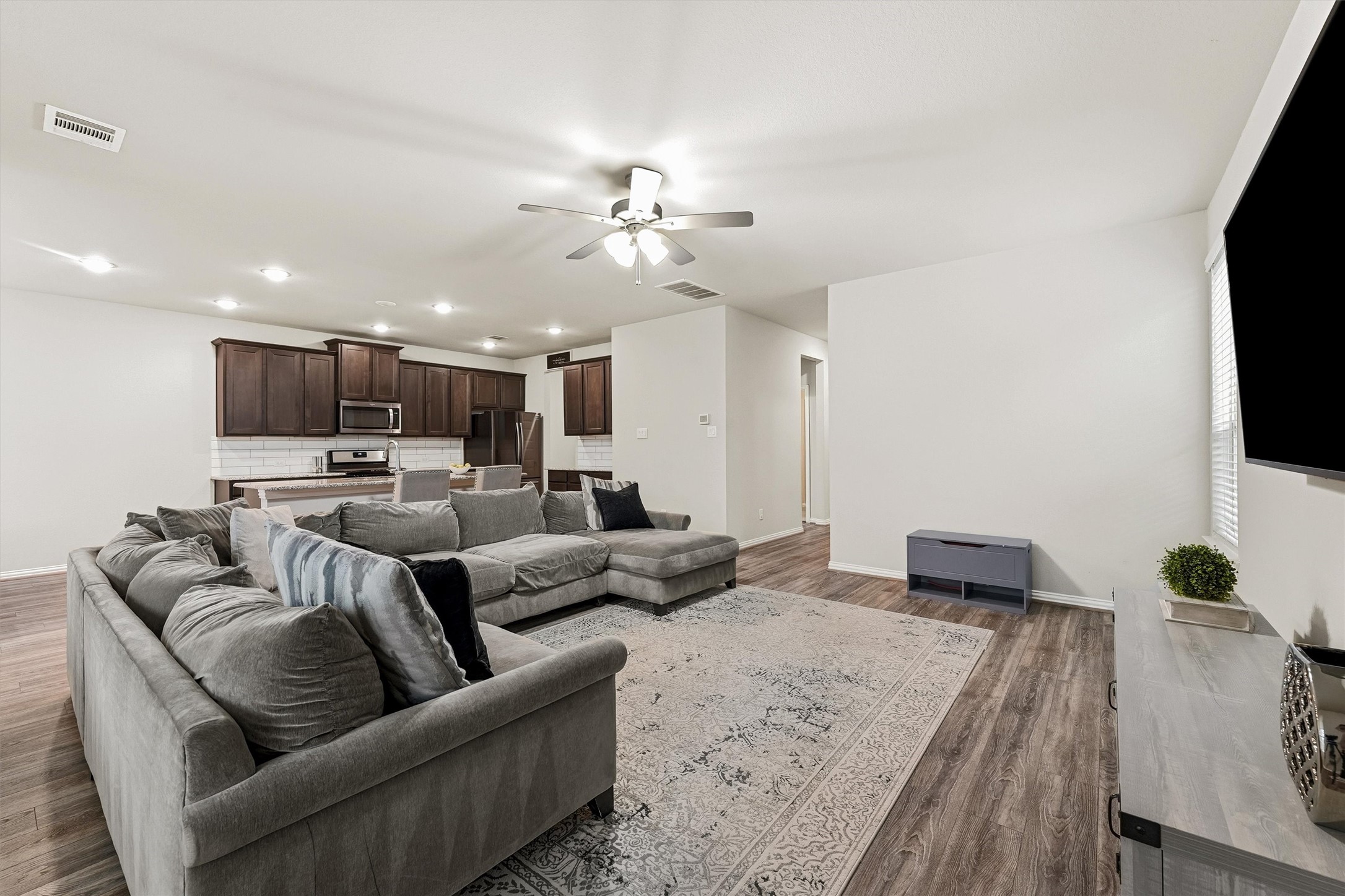 7119 Mystic Morning Lane Spring, TX 77379 - Photo 7 of 30 a living room with furniture and a flat screen tv
