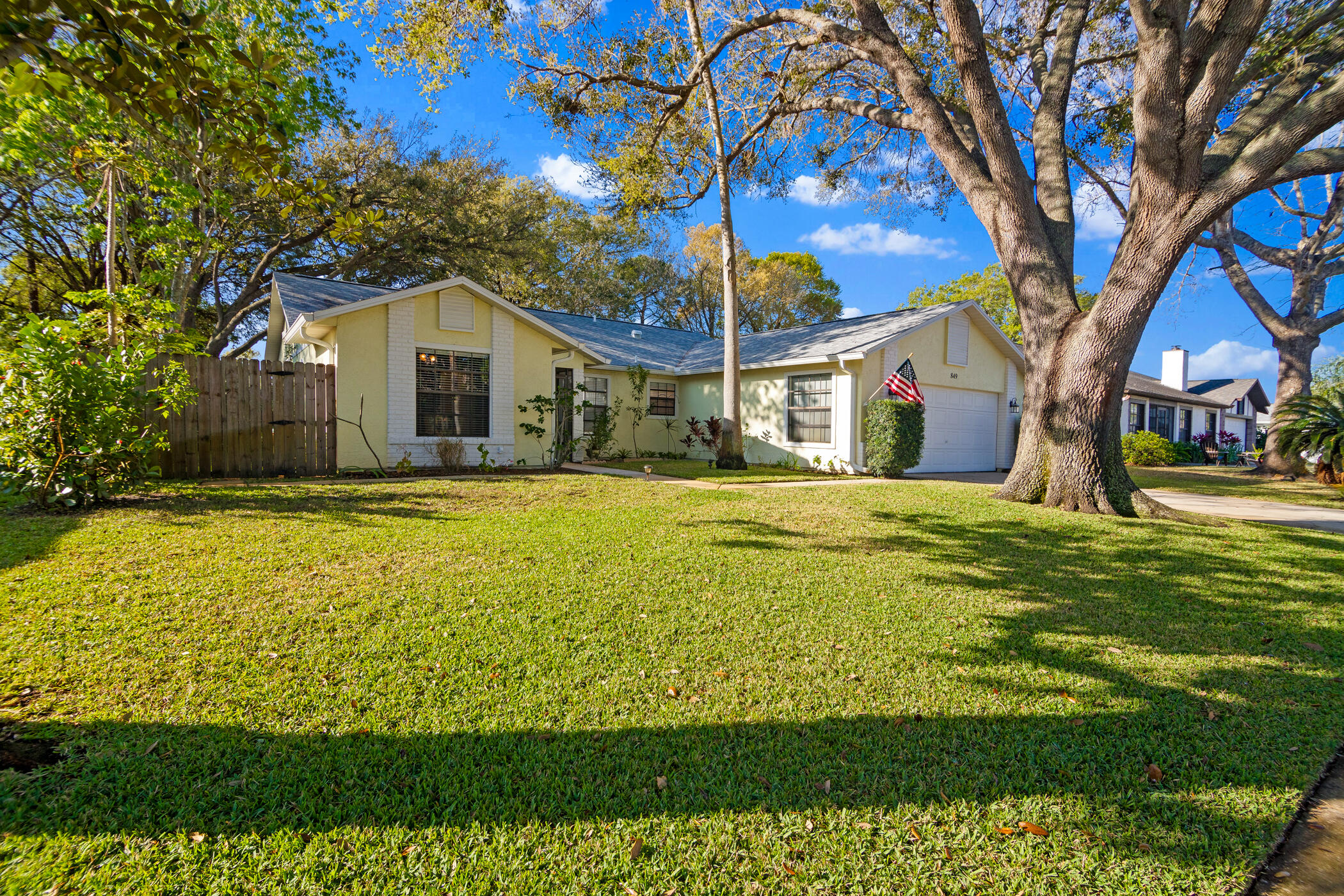 849 Gardener Road Rockledge, FL 32955 - Photo 30 of 31 a yellow house with a big yard and large trees