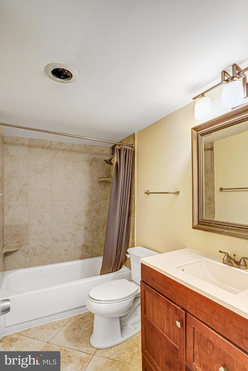 1301 20th Street Northwest, Unit 501 Washington, DC 20036 - Photo 16 of 19 a bathroom with a granite countertop sink toilet and shower