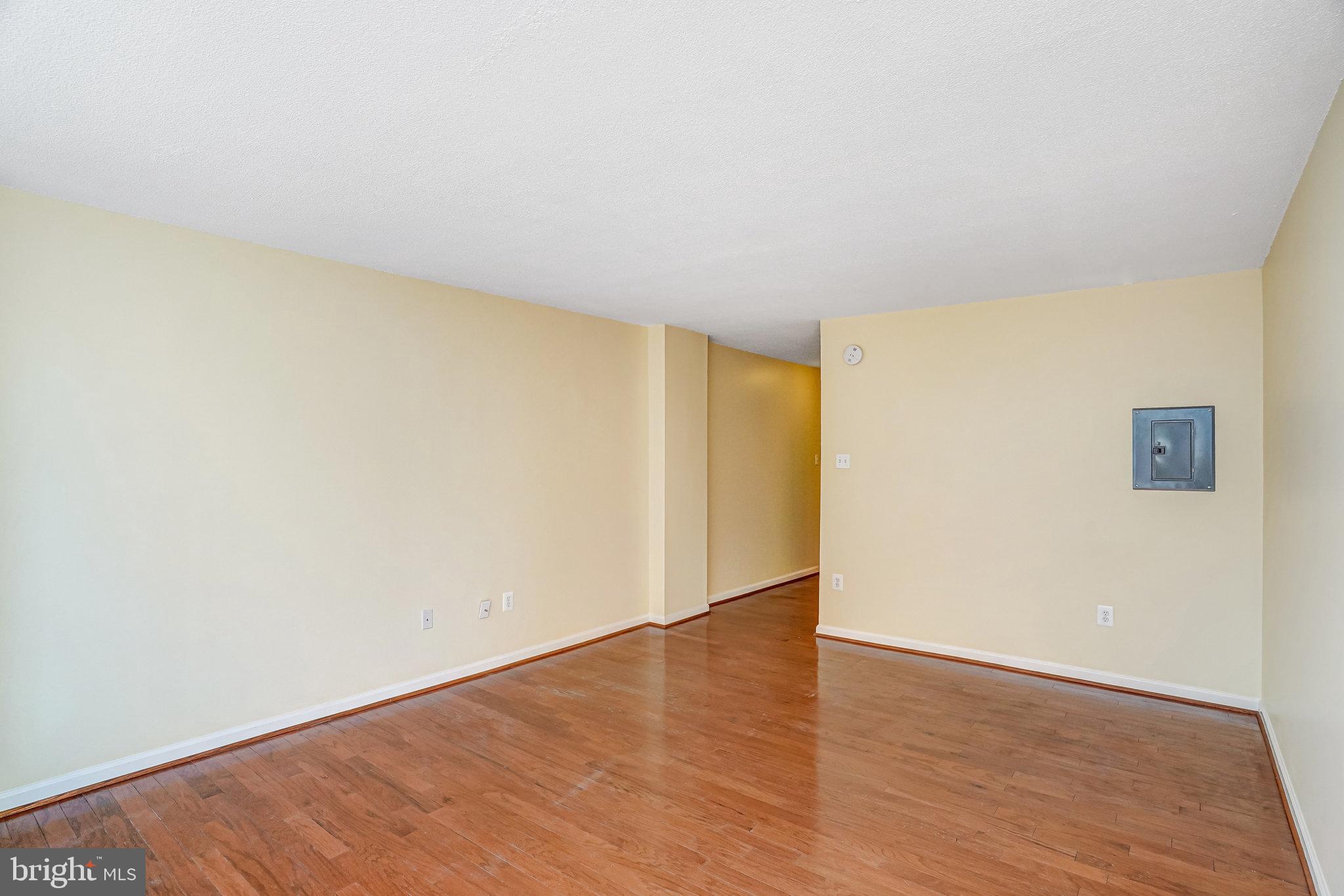 1301 20th Street Northwest, Unit 501 Washington, DC 20036 - Photo 9 of 19 a view of an empty room with wooden floor and a window