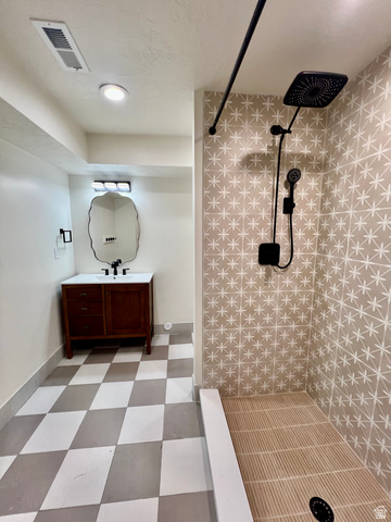 812 East Bates Cyn Road Tooele, UT 84074 - Photo 82 of 144 Bathroom featuring a walk-in shower with patterned tile surround and an integrated rain showerhead