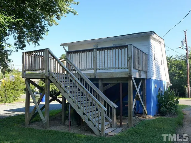 a view of a roof deck with couches and floor to ceiling window