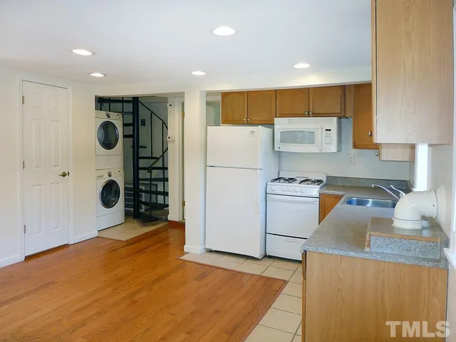a kitchen with refrigerator and cabinets