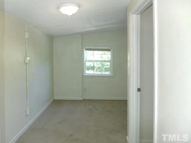 a view of an empty room and a window