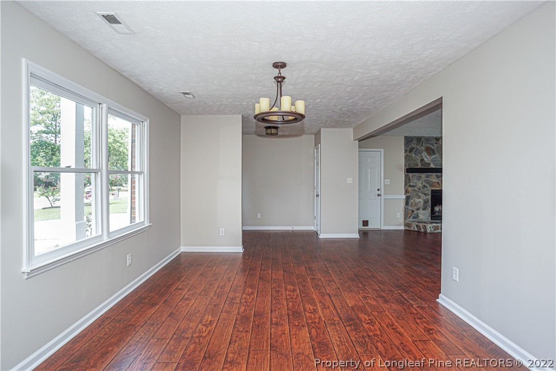 911 Rim Road Fayetteville, NC 28314 - Photo 11 of 38 wooden floor in an empty room with a window