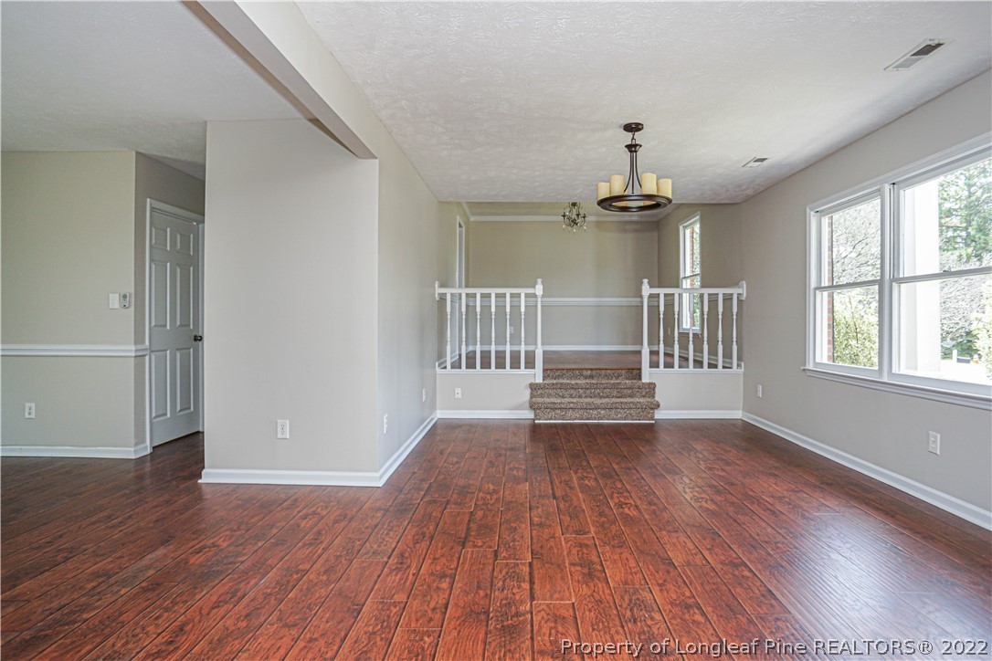 911 Rim Road Fayetteville, NC 28314 - Photo 8 of 38 wooden floor in an empty room with a window