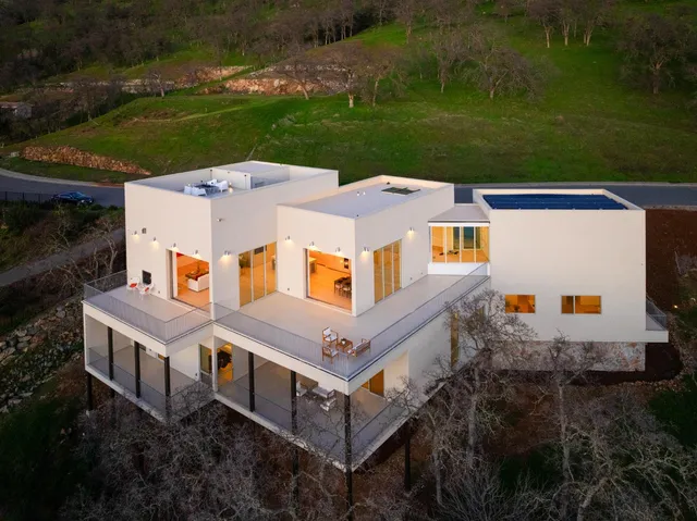 an aerial view of a house with a yard