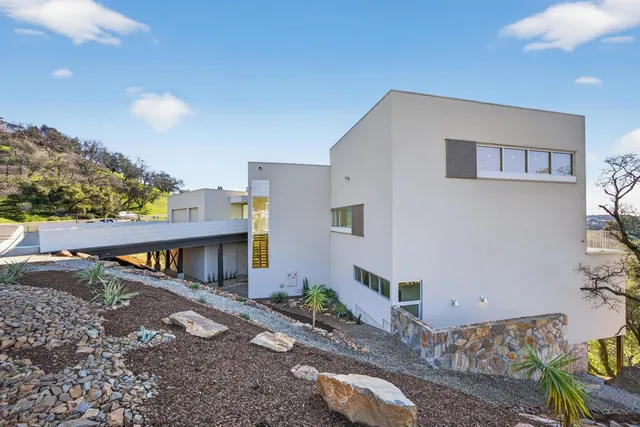a view of a dining room with furniture a rug and a floor to ceiling window