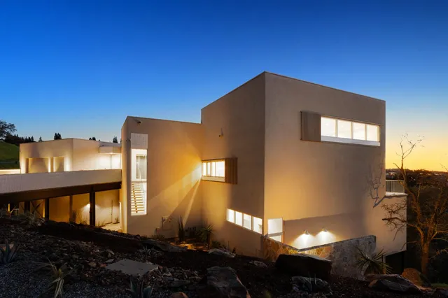 a kitchen with a table chairs sink and cabinets