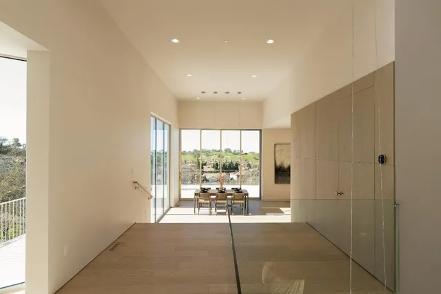 a kitchen with stainless steel appliances granite countertop a sink a stove and a wooden floors