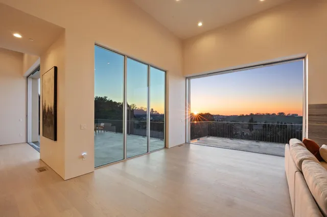 a bedroom with a bed couch and a large window