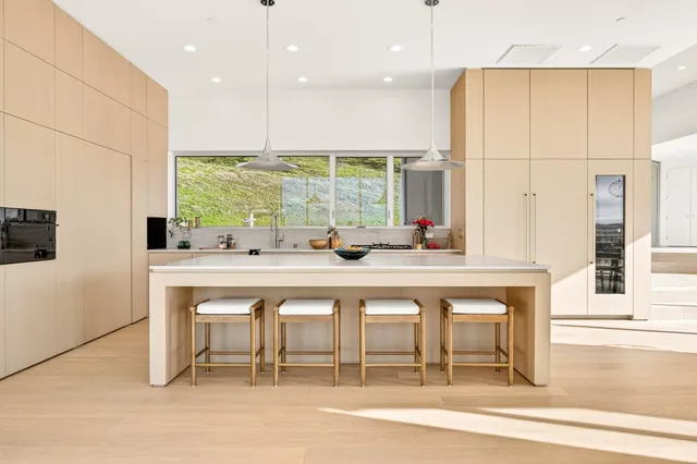 a living room with a couch and a floor to ceiling window