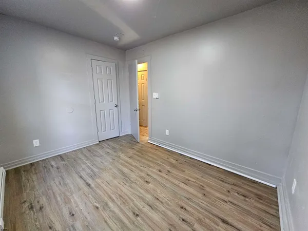 a view of an empty room and wooden floor
